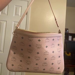 Pink MCM pouch with short handle.